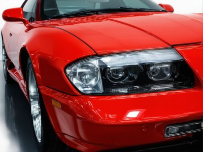 Custom auto paint job with technician applying paint to vehicle
